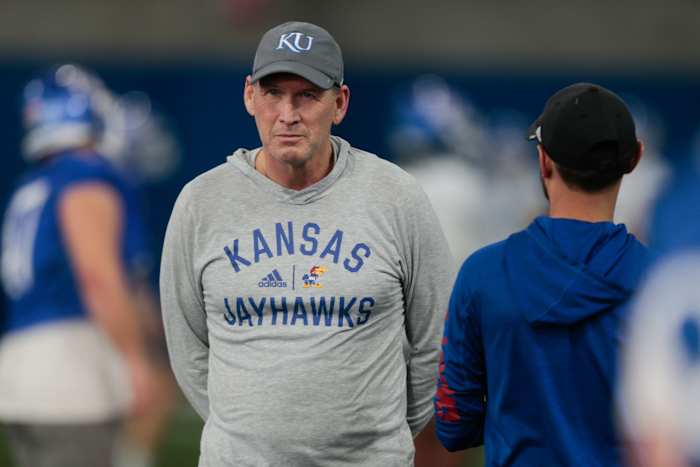 Kansas coach Lance Leipold talks with staff during practice Tuesday morning in Lawrence.